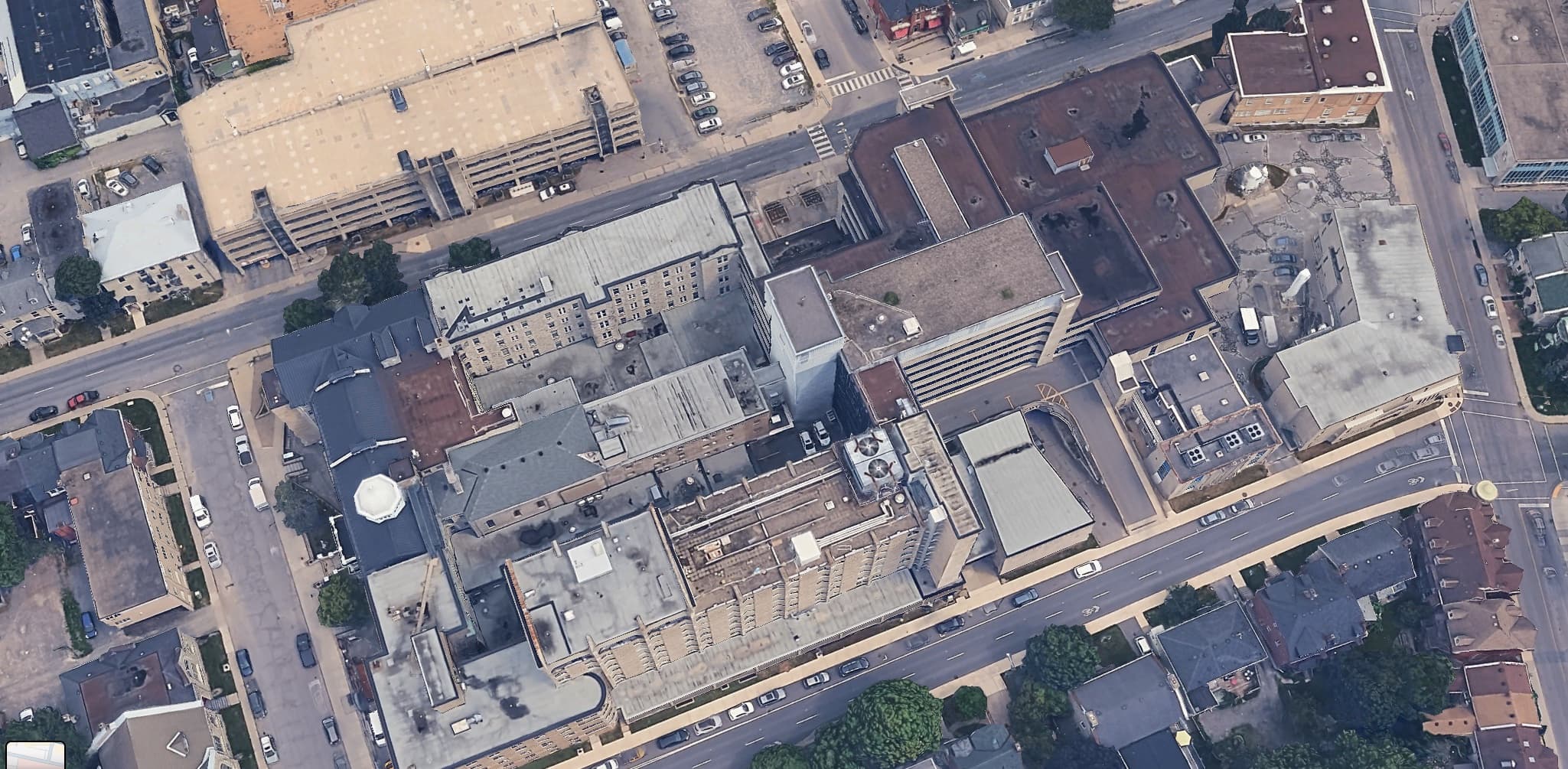 Aerial view of a downtown commercial building roof with rooftop equipment, ahead of a roof condition inspection